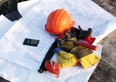 Castellon Services Corp construction blueprints and safety hard hat